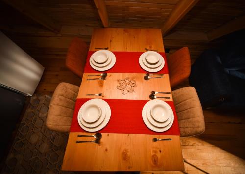 a table with plates and napkins on top of it at BADEM AĞACI BUGALOWLARI in Kas