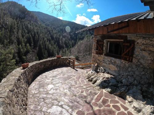 a stone building with a view of a mountain at Maison Maralpine in Roubion