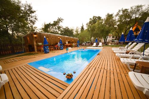 a swimming pool with chairs and a turtle in the water at BADEM AĞACI BUGALOWLARI in Kas