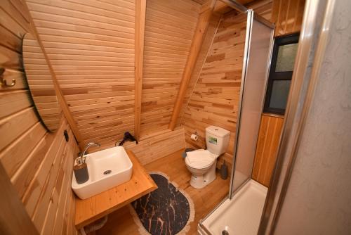 a small bathroom with a sink and a toilet at BADEM AĞACI BUGALOWLARI in Kas