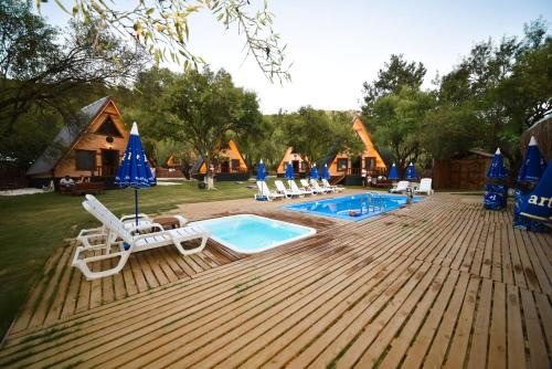 a swimming pool with lounge chairs and a resort at BADEM AĞACI BUGALOWLARI in Kas