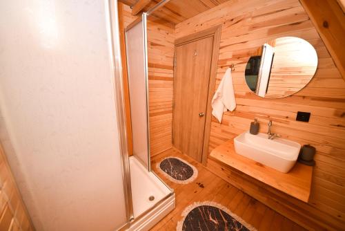 a bathroom with a shower and a sink at BADEM AĞACI BUGALOWLARI in Kas