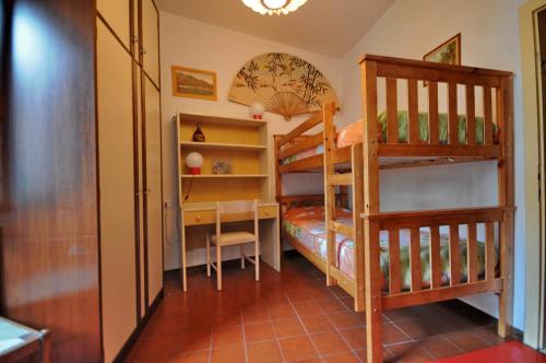 a bedroom with two bunk beds and a ladder at Casa Anna in Ledro