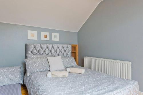 a bedroom with a bed with two pillows on it at Dublin Home by Clonsilla train 25min to City in Dublin