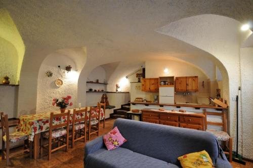 a living room with a couch and a kitchen at Casa Anna in Ledro