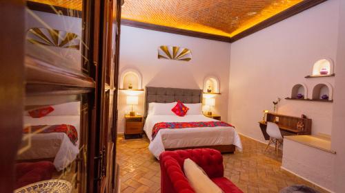 a hotel room with two beds and a couch at Casa Eva Hotel Boutique & Spa in Cholula