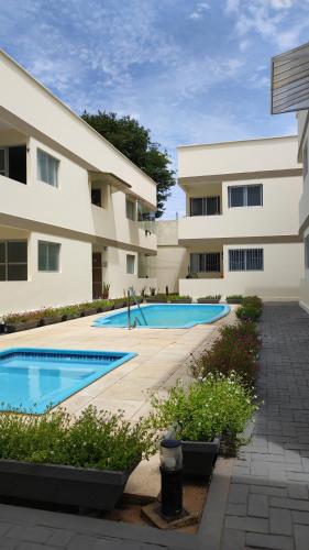 a building with two swimming pools in front of it at Pipa Céu Azul in Pipa