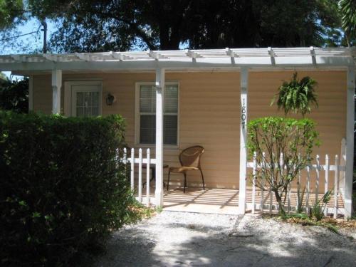 a small house with a chair on a porch at Pirates Pointe Resort in Ruskin