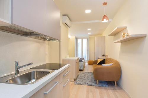 a kitchen with a sink and a chair in a room at Mono Via Bellinzona in Como