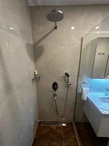 a bathroom with a shower and a sink at Side Holiday House in Side