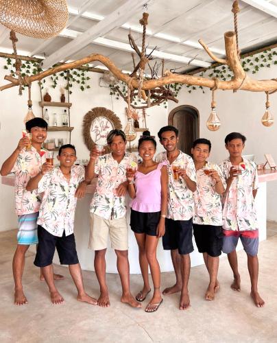 a group of people holding up glasses of wine at VILLA LA ISLA BONITA walking distance to the beach in Gili Air