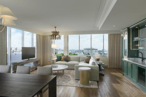 a living room with a couch and a table at The Palmetto Hotel, Charleston in Charleston