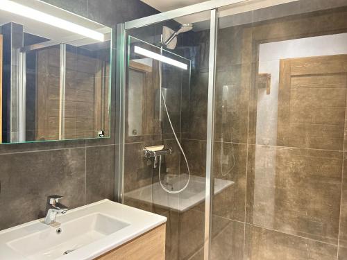 une salle de bain avec une douche, un lavabo et un miroir dans l'établissement Appartement de Standing au Centre des Gets, Proche Pistes, 2 Ch, Terrasse, Parking, WiFi - FR-1-623-6, aux Gets