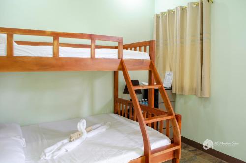 a couple of bunk beds in a room at MS Mountain Cabin in Loboc