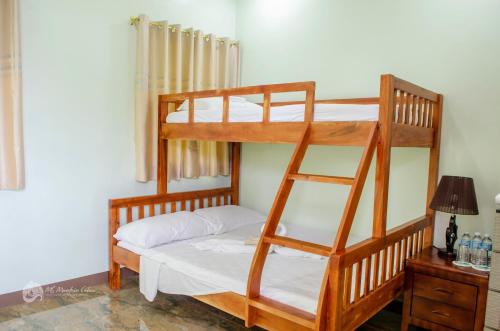 a bedroom with two bunk beds in a room at MS Mountain Cabin in Loboc