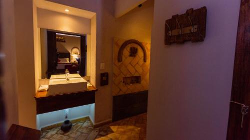 a bathroom with a sink and a mirror at Casa Eva Hotel Boutique & Spa in Cholula