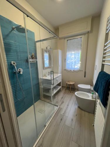 a bathroom with a shower and a tub and a sink at Casa Marina Giardino delle Rose in Marina di Carrara