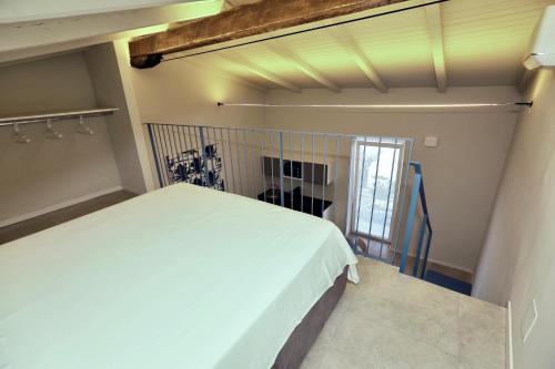 a bedroom with a white bed in a room at Casa Bomma in Messina