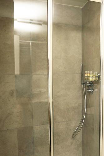 a shower with a glass door in a bathroom at Casa Bomma in Messina