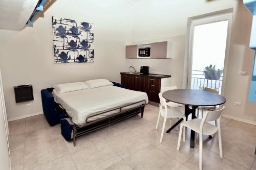 a bedroom with a bed and a table and chairs at Casa Bomma in Messina