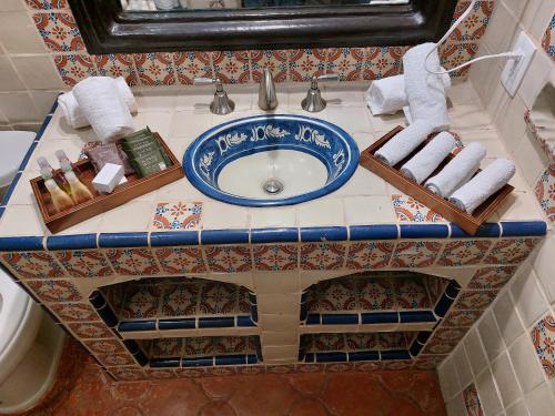 a bathroom counter with a sink and towels on it at Casa Yollotzin in Ajijic