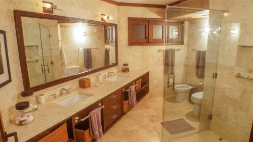 a bathroom with two sinks and a shower and a toilet at Sunny Vacation Villa No 41 in San Rafael del Yuma