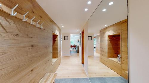 a hallway with wood paneling and a glass wall at Cresta Ellie in St. Moritz