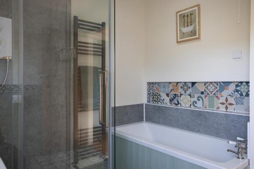 a bathroom with a shower and a sink at Brecon Beacons Cottage with Stunning Country Views in Myddfai