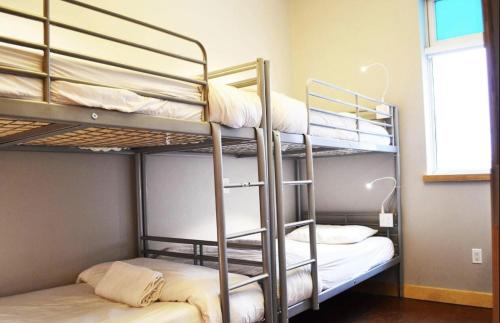 two bunk beds in a room with a window at Central Station B&B Naples in Naples