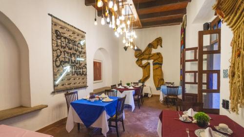 a restaurant with tables and chairs in a room at Casa Eva Hotel Boutique & Spa in Cholula