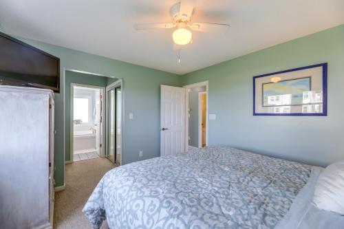 a bedroom with a bed and a ceiling fan at Ocean Front Emerald Isle Vacation Rental Property in Emerald Isle