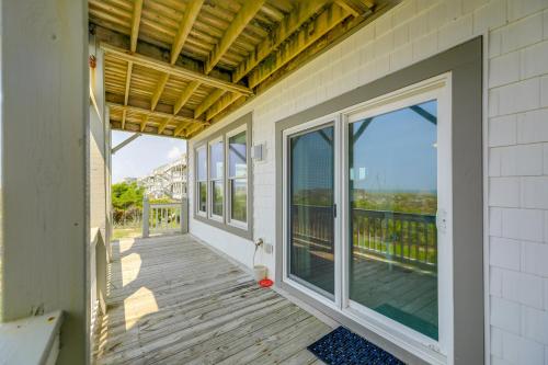 a porch with sliding glass doors on a house at Ocean Front Emerald Isle Vacation Rental Property in Emerald Isle