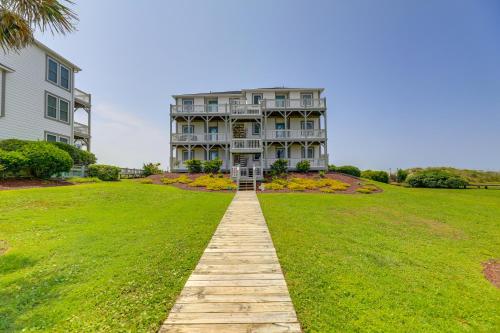 a large house on a green lawn with a walkway at Ocean Front Emerald Isle Vacation Rental Property in Emerald Isle