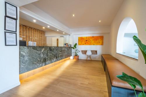 a hallway with a large marble counter in a room at Hostal Alcina in Cala Ratjada