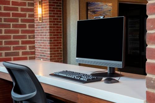 a computer monitor and a keyboard on a desk at Residence Inn by Marriott Norwalk in Norwalk