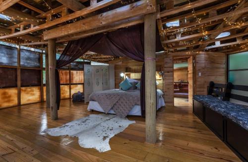 a bedroom with a bed in a room with wooden ceilings at The Lantern @ Fantasia in Hogsback