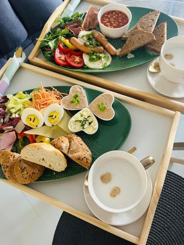 a tray with two plates of food on a table at Vila LEMAR wellness & spa in Huncovce