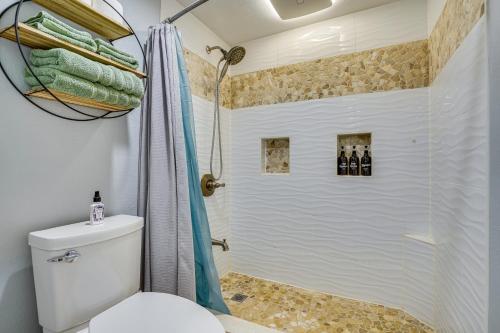 a bathroom with a shower and a toilet at Kaunakakai Vacation Rental with Pool Access and A and C! in Kaunakakai