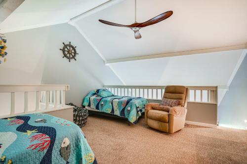 a bedroom with a bed and a chair and a clock at Kaunakakai Vacation Rental with Pool Access and A and C! in Kaunakakai