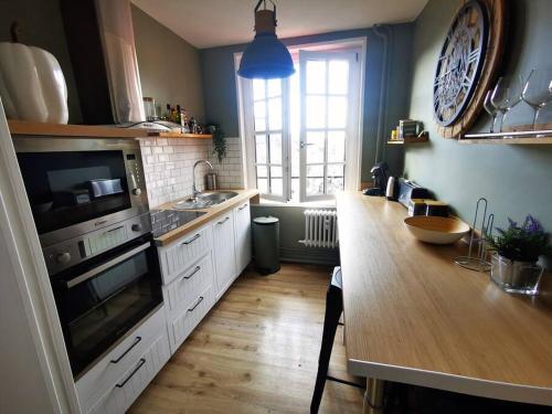 a kitchen with a sink and a stove top oven at Mademoiselle de Champmeslé in Rouen