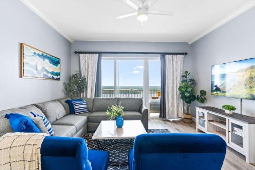 a living room with a couch and blue chairs at Spectacular view Blue Heron Beach Resort Near Disney in Orlando