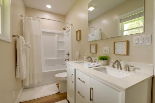 a white bathroom with a sink and a toilet at Dog-Friendly Jackson Home Near Downtown Hub! in Jackson