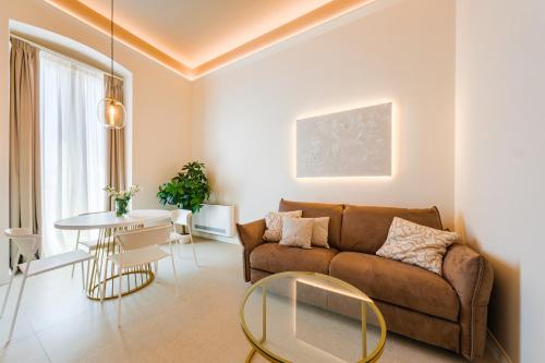 a living room with a couch and a table at HelloAPULIA Charming Palazzo Clemente - self-catering suites with aircondition in Monopoli
