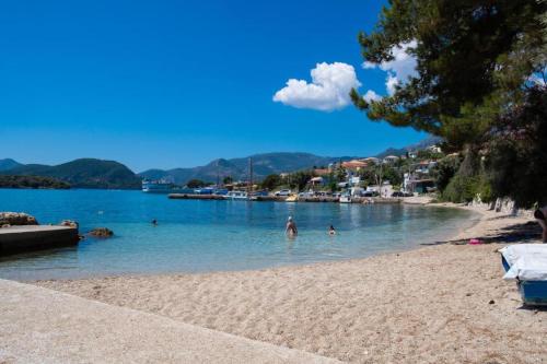 a group of people in the water at a beach at Nikolaos Apartment 2 in Nydri