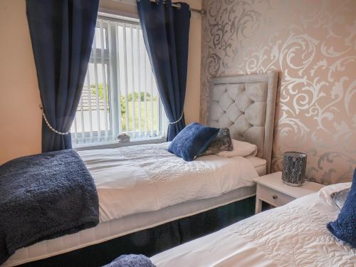 a bedroom with two beds and a window at Field View in Saltburn-by-the-Sea