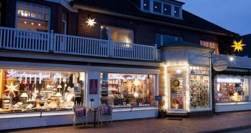 a store front with chairs in front of a building at FeWo Olga Behrends in Wiesmoor