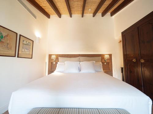 a bedroom with a large white bed with two pillows at Ca'n Puig de Sòller in Sóller