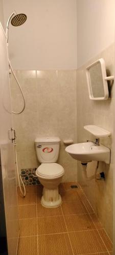 a bathroom with a toilet and a sink at La maison de Soriya - Homestay in Kampot