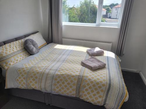 a bedroom with a bed with two pillows and a window at Beautiful 3-Bed House in Ramsgate in Ramsgate