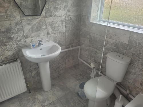 a bathroom with a toilet and a sink at Beautiful 3-Bed House in Ramsgate in Ramsgate